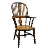 A 19th century yew wood Windsor elbow chair.