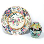 A large late 19th/early 20th century Chinese porcelain Famille Rose circular charger painted in