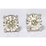 A pair of 9ct white gold diamond stud earrings, each stone weighing approx 0.20ct, with screw backs.