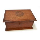 An oak trinket box with carved detail to the lid and inscribed 'This oak was part of