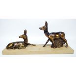 An Art Deco style French ornament modelled as two gazelles on a rectangular plinth, length 35cm.