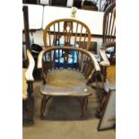 A 19th century elm seated Windsor elbow chair with crinoline stretcher.