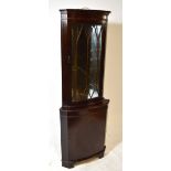A reproduction mahogany and inlaid freestanding corner cupboard,