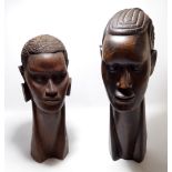 A pair of large African carved hardwood heads of a man and woman, height 60cm and 50cm (2).