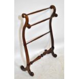 A Victorian mahogany towel rail, with scrolling supports, width 68cm.