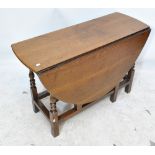 A 19th century oak dropleaf dining table with single drawer raised on turned supports to square