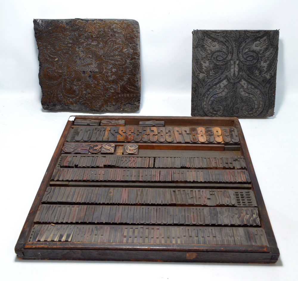 Two wooden copper and iron foliate scroll printing blocks,