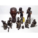 An African carved hardwood head, height 32cm, and a group of ebonised figures including fighters.