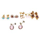 A collection of earrings including a pair of amethyst and diamond drop earrings (one diamond