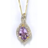 A 9ct yellow gold amethyst and diamond pendant supported on a fine link chain.
