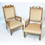 A pair of late Victorian oak cream upholstered armchairs, on turned front legs to castors (2).