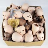 A large quantity of predominantly modern manufacture ceramic doll components comprising heads,