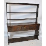 An oak dresser with open rack above three drawers above undertier, width 162cm.