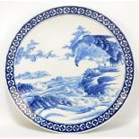 A large Japanese Meiji period porcelain circular charger painted in underglaze blue with an eagle