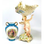 A Sitzendorf porcelain figural bowl modelled as a cherub supporting a floral encrusted decorated