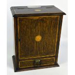 An early 20th century oak and inlaid smoker's compendium, with cupboard door beneath hinged lid,