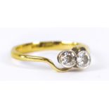 An 18ct yellow gold crossover ring set with two diamonds, each approx 0.1cts, size L, approx 2.2g.