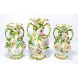 An early 19th century Coalport porcelain floral encrusted decorated trio comprising a baluster vase