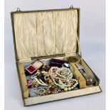 A mixed lot of costume jewellery to include necklaces, brooches, a wristwatch, etc.