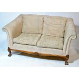 A mahogany framed upholstered sofa with cushions, on four ball and claw feet, width 158cm.