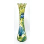 MOORCROFT; a Florian Ware floral tubeline decorated slender waisted vase with wavy rim,