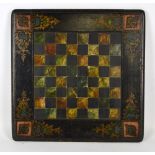 A Victorian chess board with heraldic framing, the board painted to simulate marble, 42 x 42cm,