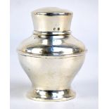 A George V hallmarked silver tea canister of squat baluster form to circular spreading base