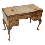 A 19th century burr walnut leather topped desk with carved foliate and swag decoration,