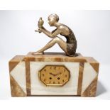 A 1950s Art Deco style two tone mantel clock surmounted with a silvered spelter figure of seated