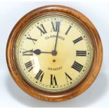 An early 20th century oak eight day circular wall clock with fusee movement,