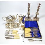 A quantity of electroplated items including a pair of candlesticks, basket, teapot, etc.