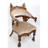 A good Victorian oak Gothic Revival upholstered bow back armchair with carved top and bottom rails,