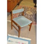 A set of four 1960s teak upholstered chairs with low bar backs (4).