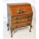 An early 20th century walnut fall-front bureau with lacquered chinoiserie decoration,