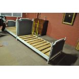 A pair of French grey painted and upholstered single beds complete with side stretchers and pine