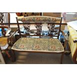An Edwardian mahogany settee with embroidery upholstered seat and back bar,