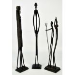 Three African bronze elongated figures on rectangular bases, height 45cm, 43cm and 36cm (3).