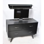 A 1970s black painted dressing table converted with a remote control rise and fall 23" LG flat