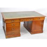 A mid-20th century mahogany partners' desk with drawers to one side and cupboards to the reverse,