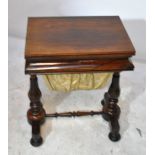 An early Victorian rosewood sewing/games table with foldover baize lined top above a frieze drawer