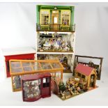 Five doll's shop displays, the tallest of three stories, containing various figures,