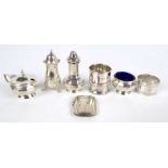 A George V hallmarked silver three piece cruet set, Birmingham 1925, a hallmarked silver vesta case,