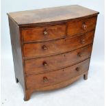 A Victorian flame mahogany bow fronted chest of two short and three long drawers on bracket feet,