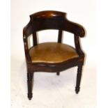 A Victorian mahogany serpentine fronted smoker's chair with leather seat above turned and reeded