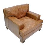 HALO; a tan leather upholstered armchair.