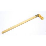 An unusual Victorian walking cane handle with carved vegetable ivory angled grip modelled as a