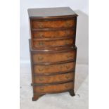 A reproduction walnut bowfronted chest on chest of small proportions,