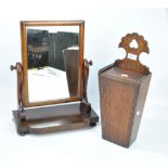 A George III oak and mahogany crossbanded candle box with shaped back plate and sliding lid,