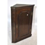 A George III oak corner cupboard, width approx 70cm.