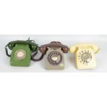 Three vintage telephones.